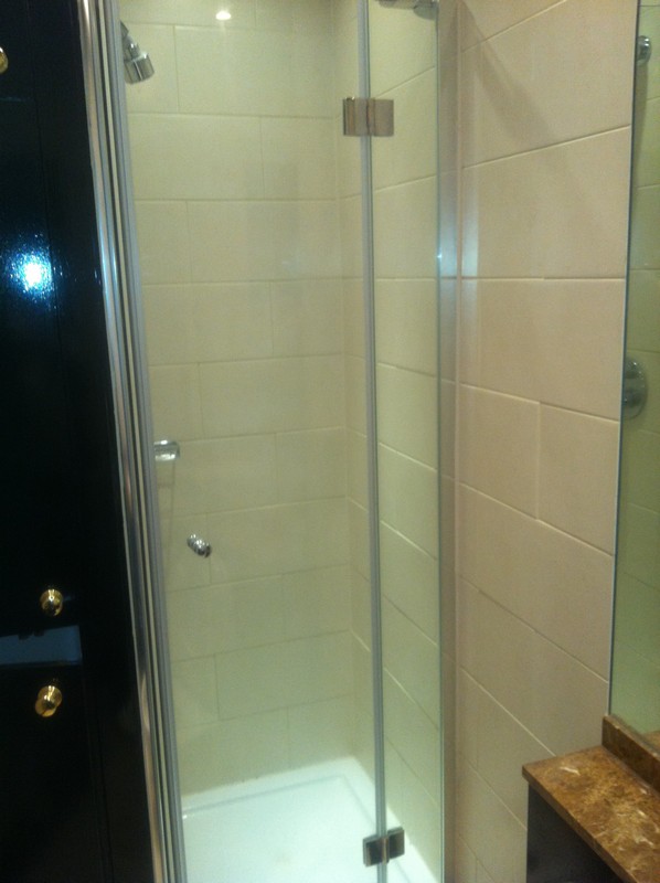 Frameless glass shower enclosure with chrome fittings in Manor Park