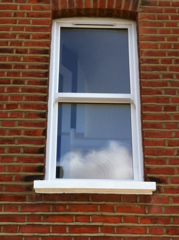uPVC sash window on Victorian red brick house in Manor Park